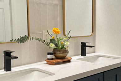 Alcove shower - small scandinavian 3/4 beige tile and ceramic tile cement tile floor, gray floor and double-sink alcove shower idea in Los Angeles with blue cabinets, a one-piece toilet, white walls, an undermount sink, quartz countertops, a hinged shower door, white countertops and a built-in vanity