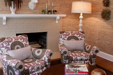 Example of a mid-sized trendy enclosed dark wood floor and brown floor family room design in DC Metro with brown walls, a standard fireplace, a brick fireplace and no tv