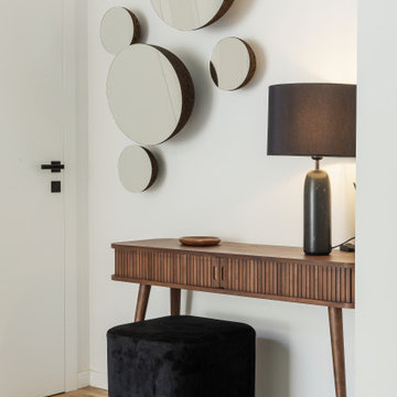 Entry Hall with Circular Mirrors and Wood Console
