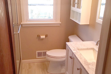 Medium sized classic family bathroom in Other with shaker cabinets, beige cabinets, a two-piece toilet, beige walls, a submerged sink, engineered stone worktops, an alcove shower, porcelain flooring, beige floors and a sliding door.