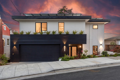 Example of a mid-sized trendy white three-story stucco exterior home design in San Francisco with a white roof