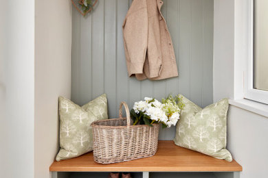 Inspiration for a medium sized rural porch in Surrey with beige walls, porcelain flooring, a single front door, a green front door, multi-coloured floors, a drop ceiling, tongue and groove walls and feature lighting.
