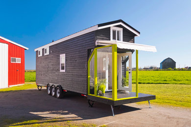 Inspiration for a small contemporary two-storey black exterior in Vancouver with wood siding and a gable roof.