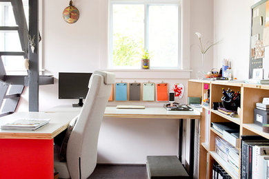 Example of a small minimalist built-in desk dark wood floor home office library design in New York with white walls