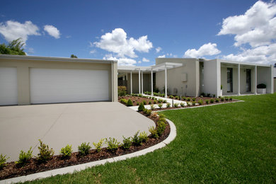 Expansive modern one-storey concrete beige exterior in Newcastle - Maitland.