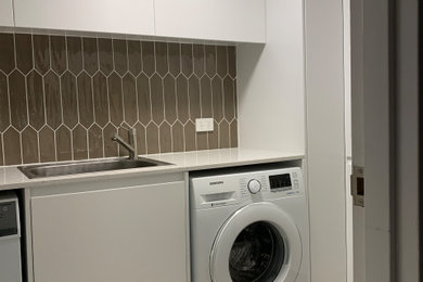 Photo of a contemporary laundry room in Sydney.