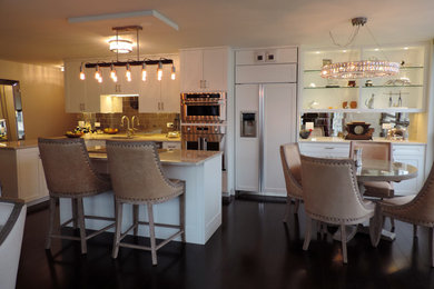 Inspiration for a small eclectic single-wall laminate floor and brown floor eat-in kitchen remodel in Chicago with shaker cabinets, white cabinets, granite countertops, metallic backsplash, mirror backsplash, stainless steel appliances and an island