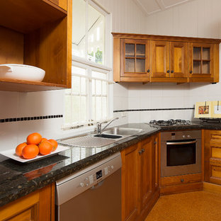 Design ideas for a small traditional l-shaped kitchen pantry in Gold Coast - Tweed with a double-bowl sink, recessed-panel cabinets, medium wood cabinets, quartz benchtops, white splashback, ceramic splashback, stainless steel appliances and cork floors.