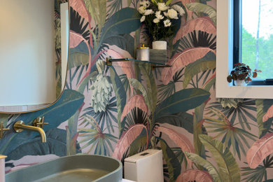 Small trendy wallpaper powder room photo in Toronto with light wood cabinets, multicolored walls and a floating vanity