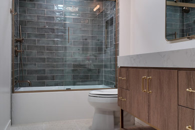 Bathroom - mid-sized contemporary turquoise tile and subway tile terrazzo floor, gray floor and single-sink bathroom idea in Los Angeles with flat-panel cabinets, medium tone wood cabinets, a one-piece toilet, white walls, a drop-in sink, quartzite countertops, white countertops, a niche and a freestanding vanity