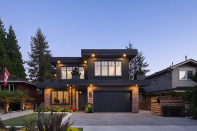 Contemporary black two-story exterior home idea in Vancouver