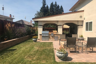 Inspiration for a mid-sized partial sun backyard brick landscaping in San Francisco with a fire pit for spring.