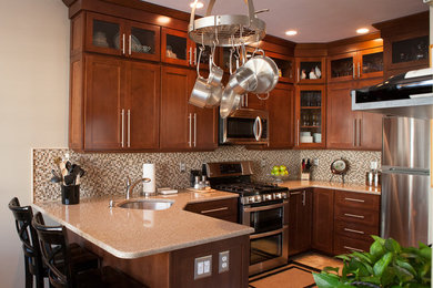 Inspiration for a small transitional u-shaped travertine floor and beige floor eat-in kitchen remodel in New York with an undermount sink, shaker cabinets, brown cabinets, quartz countertops, multicolored backsplash, mosaic tile backsplash and white appliances
