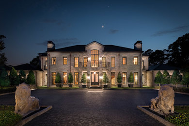 Huge elegant gray two-story stone exterior home photo in Houston