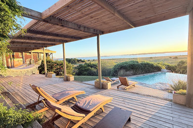 This is an example of a beach style swimming pool in Other.
