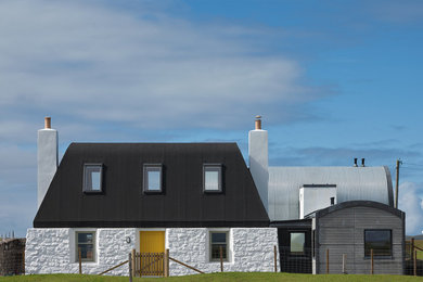 Photo of a contemporary two-storey white exterior in London with mixed siding.