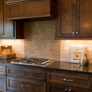 Huge craftsman kitchen pantry inspiration - Kitchen pantry - huge craftsman l-shaped dark wood floor kitchen pantry idea in Kansas City with an undermount sink, shaker cabinets, dark wood cabinets, granite countertops, beige backsplash, stone tile backsplash, stainless steel appliances and an island