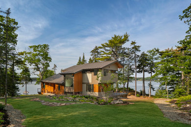 Large contemporary two-story mixed siding exterior home idea in Portland Maine with a metal roof