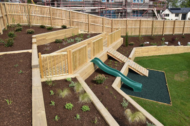 Extensive terraced raised beds with decking and play area.