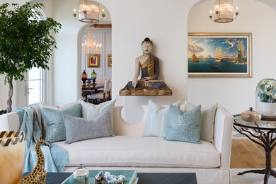 Mid-sized tuscan formal and enclosed light wood floor and brown floor living room photo in San Diego with white walls, a standard fireplace and a plaster fireplace