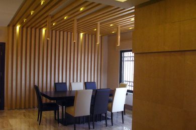 Example of a small trendy marble floor enclosed dining room design in Other with beige walls and no fireplace