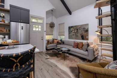 Inspiration for a small southwestern loft-style vinyl floor, beige floor and vaulted ceiling living room remodel in Miami with white walls
