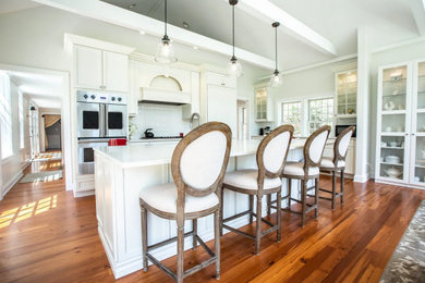 French country kitchen photo with shaker cabinets and an island
