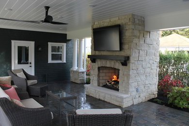 Example of a large transitional backyard tile patio design in Other with a fire pit and a roof extension