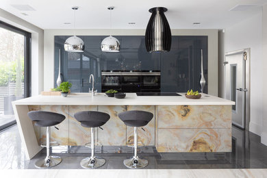 Photo of a large contemporary galley kitchen pantry in Hertfordshire with a submerged sink, flat-panel cabinets, distressed cabinets, quartz worktops, black appliances, porcelain flooring, an island, grey floors and white worktops.