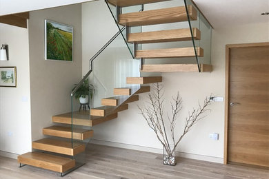 Custom made staircase with  oak treads and contemporary glass balustrade