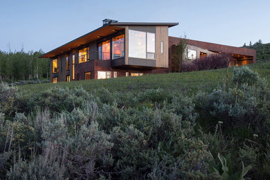 Inspiration for a large contemporary brown two-story mixed siding exterior home remodel in Other with a metal roof
