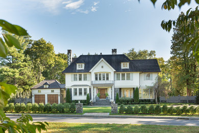 Example of a classic white two-story mixed siding house exterior design in New York with a hip roof