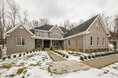 Inspiration for a large craftsman gray two-story brick exterior home remodel in Other with a tile roof