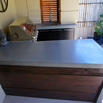 Outdoor Kitchen | polished concrete worktops, black cabinets and dark timber