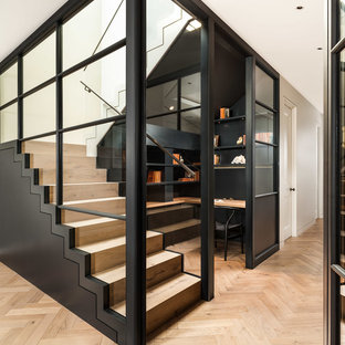Photo of a contemporary wood u-shaped staircase in London with wood risers.