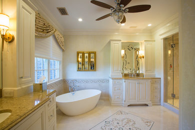 Bathroom - large traditional master beige tile and travertine tile travertine floor and beige floor bathroom idea in DC Metro with raised-panel cabinets, beige cabinets, a bidet, beige walls, an undermount sink, granite countertops and a hinged shower door