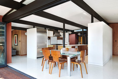 Inspiration for a small midcentury kitchen/dining combo in San Francisco with red walls, vinyl floors, no fireplace and white floor.