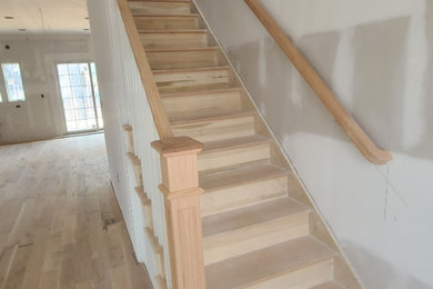 Inspiration for a mid-sized coastal wooden straight wood railing staircase remodel in New York with wooden risers