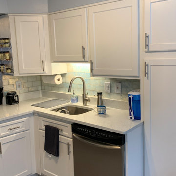 cabinet refacing---white cabinets with white quartz and glazed backsplash