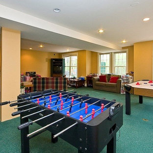 Photo of an expansive classic walk-out basement in Boston with yellow walls, carpet and turquoise floors.