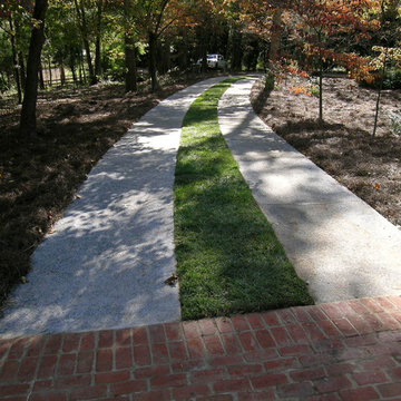 Exposed Aggregate Driveway Strips stained with Gray color and washed.
