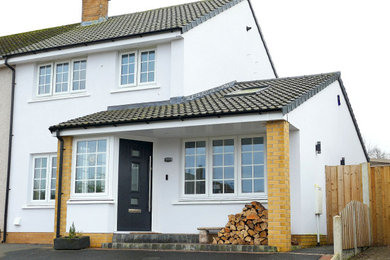 Design ideas for a white and medium sized contemporary two floor brick and front house exterior in Other with a pitched roof, a tiled roof and a grey roof.