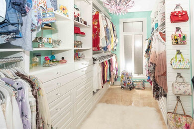 Example of a large minimalist women's walk-in closet design in Other with raised-panel cabinets and white cabinets