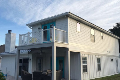 Mid-sized transitional white two-story exterior home idea in Jacksonville with a metal roof
