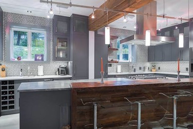 Eat-in kitchen - huge contemporary l-shaped eat-in kitchen idea in New York with an undermount sink, flat-panel cabinets, gray cabinets, quartz countertops, stainless steel appliances and an island