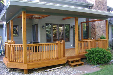 Inspiration for a gray two-story vinyl exterior home remodel in Omaha