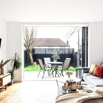 Contemporary Living Room connected to the garden , grey sofa, terracota and plan