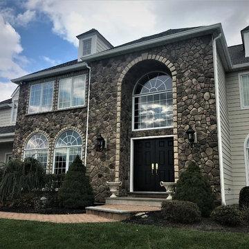 Installing Beige-Toned Stone and Hardie Siding