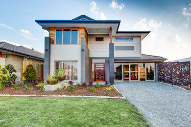 This is an example of a contemporary one-storey stucco grey exterior in Brisbane.