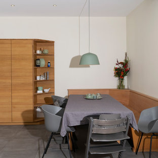 Huge contemporary kitchen pantry designs - Kitchen pantry - huge contemporary u-shaped gray floor kitchen pantry idea in Bremen with a drop-in sink, flat-panel cabinets, light wood cabinets, granite countertops, no island and black countertops